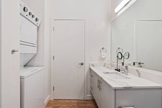 A white bathroom with a white oven and a white door.
