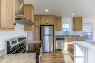 A kitchen with wooden cabinets and stainless steel appliances.