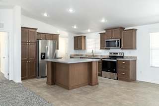 A kitchen with brown cabinets and stainless steel appliances.