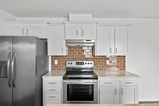 A kitchen with a stove, oven, and refrigerator.