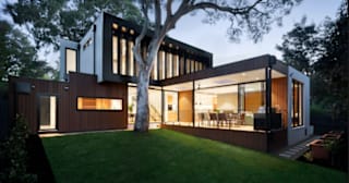 A modern house with a tree in front of it.