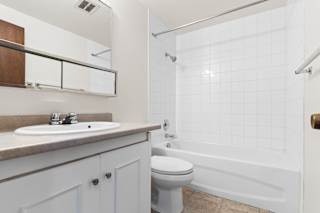 A white bathroom with a sink, toilet, and bathtub.