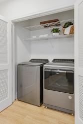 a small laundry room with two washes and a dryer
