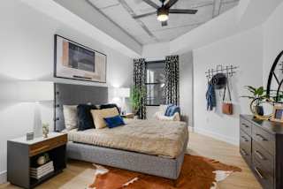 a bedroom with a bed and a ceiling fan