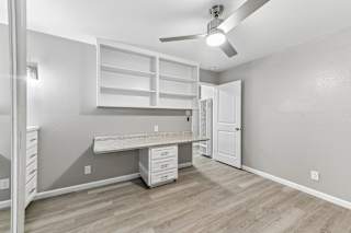 A room with a desk and drawers in it.
