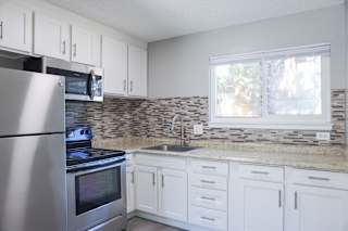 A kitchen with a stove, oven, and sink.
