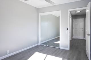 A room with a white door and a white mat on the floor.