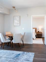 A dining room with a table and chairs.