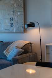A lamp stands on a table in a living room.