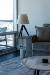 A table with a lamp and a cup on it.