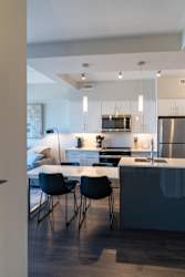A modern kitchen with a dining table and chairs.
