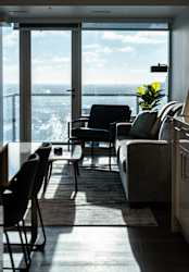 A living room with a view of the ocean through a large window.