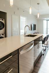 A modern kitchen with a large island and stainless steel appliances.