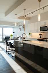 A modern kitchen with a dining table and chairs.