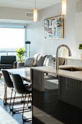 A modern kitchen with a dining table and chairs.
