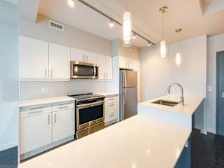 a kitchen with white cabinets and stainless steel appliances