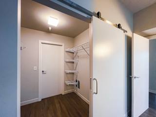 a small bedroom with a large mirror and a closet with a mirrored door