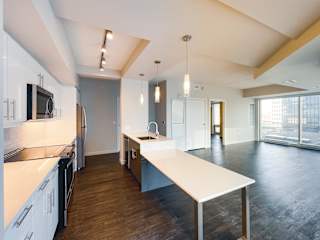 a kitchen and dining area in a 555 waverly unit