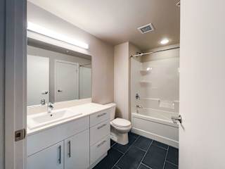 a bathroom with a white sink and toilet next to a white bathtub