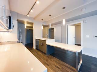 a kitchen with white countertops and blue cabinets