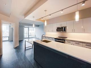 a kitchen with white cabinets and black countertops