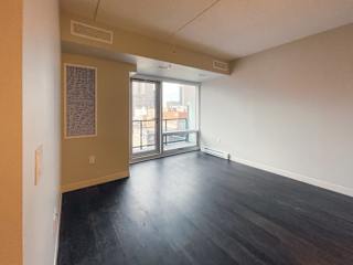 an empty living room with a balcony