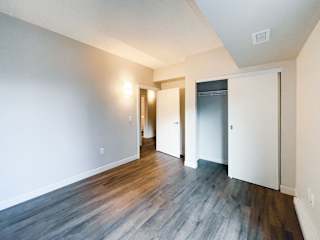 a living room with hardwood floors and white walls