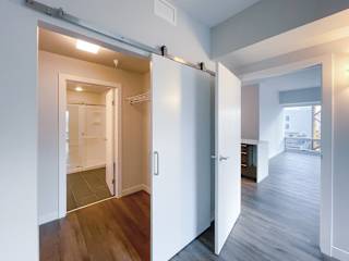 a bedroom with a medium hardwood floor and a closet with a sliding door