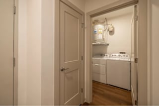 A small laundry room with a washer and dryer.