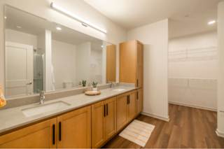 A bathroom with a sink and mirror.