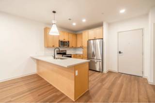 A kitchen with wooden cabinets and a white countertop.