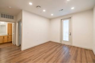 A room with wooden floors and white walls.