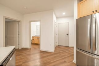 A kitchen with a refrigerator on the right.