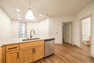 A kitchen with wooden cabinets and a white countertop.