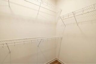 A white wall with a metal rack on it.
