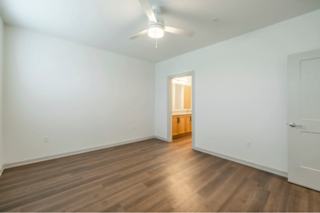 A room with wooden floors and a white ceiling with a light fixture.