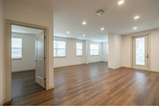A room with wooden floors and white walls.