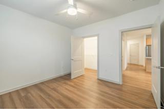 A room with wooden floors and white walls.