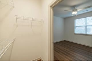 Empty room with a window and a ceiling fan.