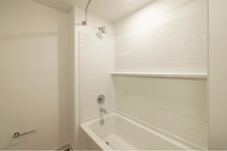 A white bathroom with a tub and shower.