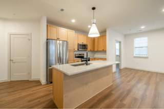 A kitchen with wooden cabinets and a white countertop.