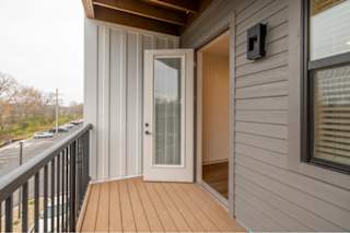 A balcony with a door and a window.
