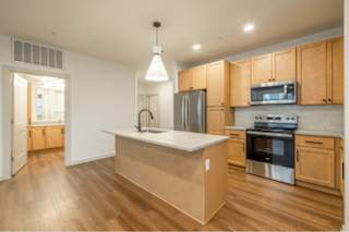 A kitchen with wooden cabinets and stainless steel appliances.
