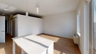 an empty living room with a white table