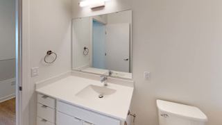 a white bathroom with a sink and a mirror