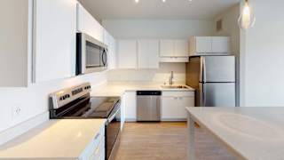 a white kitchen with a stove and a refrigerator