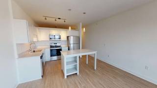 an empty kitchen with a white table and a sink