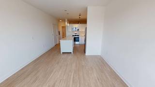 a large empty room with a dining room and a table