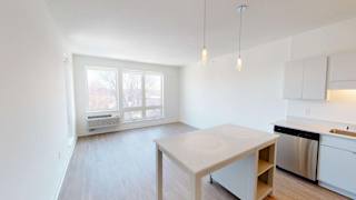 an empty kitchen with a white table and a window