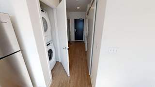 a laundry room with a washer and dryer in a hallway